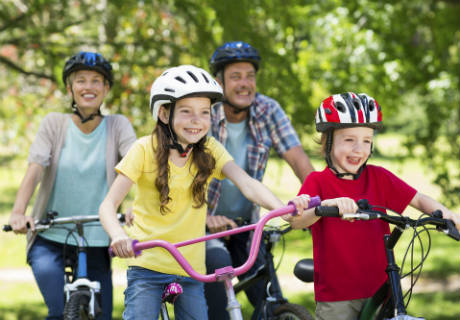 A family cycling and smiling