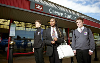 School children standing outside the entrance to Crewe Train Station
