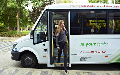 A schoolgirl leaving a bus