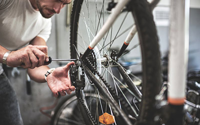 A man maintains a bicycle