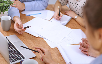 Hands of business people meeting around table